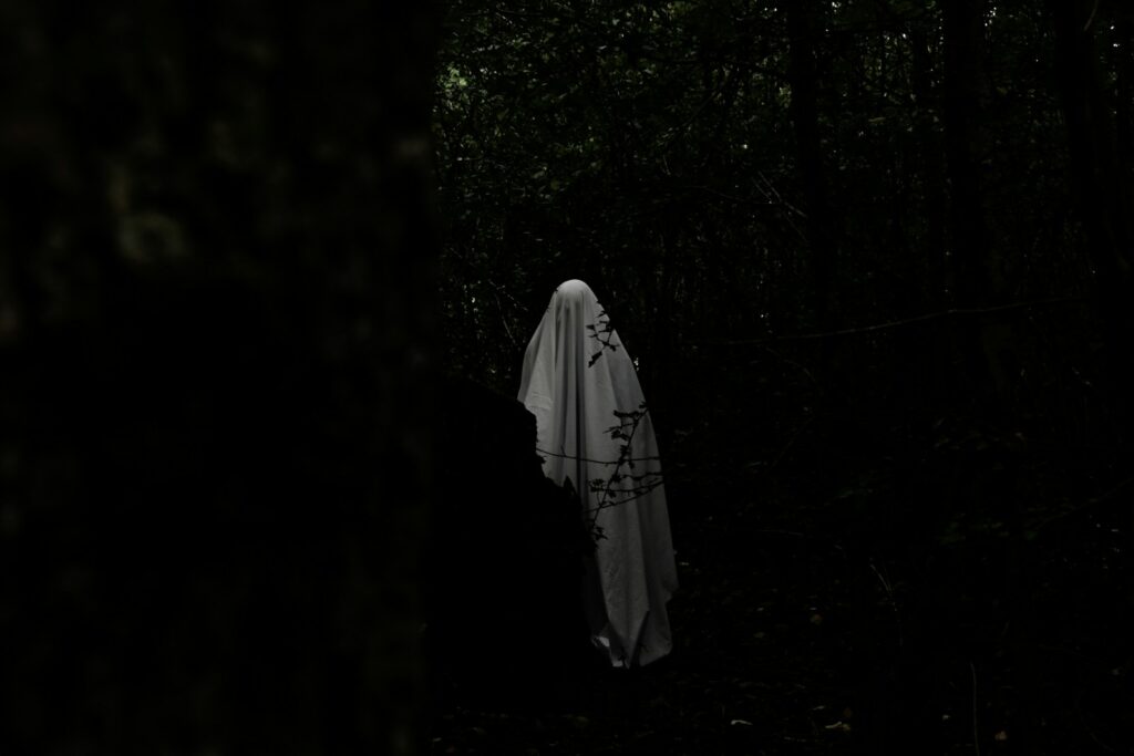 a person that is standing in the dark